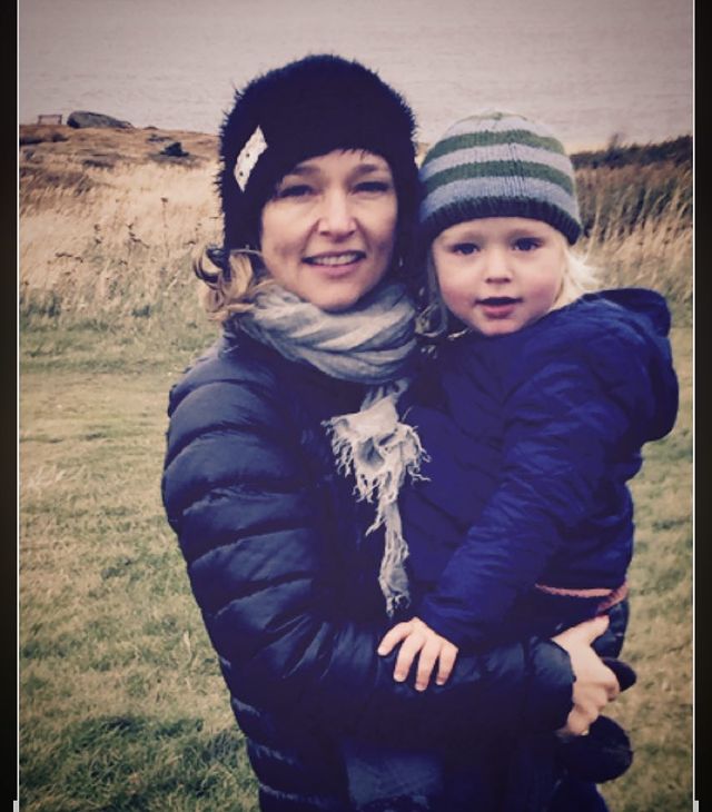 Kari matchett wearing Black jacket holding baby wearing blue jacket